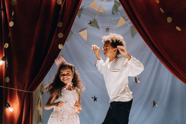 two kids performing on stage